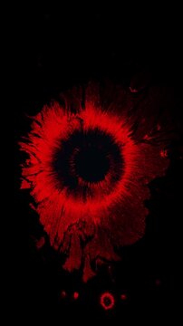 Vertical stop motion animation of a red ink drop splattering on black, perfect for horror or thriller videos