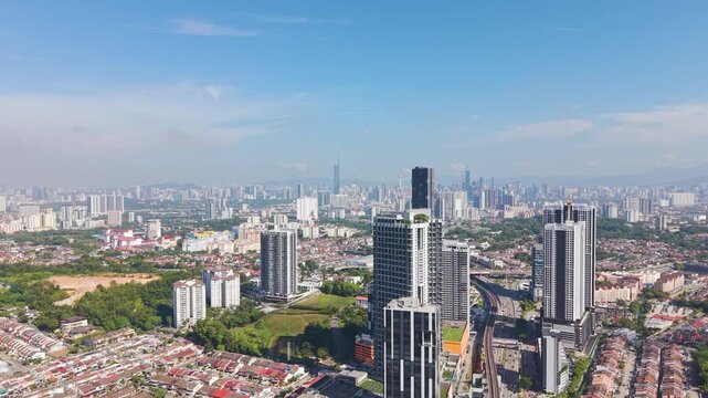 Aerial drone view of Kuala Lumpur skyline from Cheras district on a sunny day, showcasing modern high-rise buildings, urban density, and vibrant city landscape in Malaysia. UHD.
