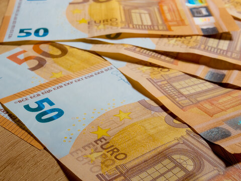 Experience an extreme close up of a 50 euro banknote revealing its unique features and designs. Discover the fine lines, patterns, and colors in this macro perspective.