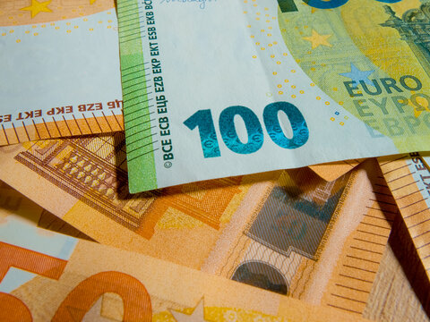 Explore the fine details of a Euro banknote with a macro perspective that captures its unique features and vibrant colors, highlighting the artistry of currency design.