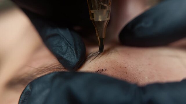 Precision view of a beauty technician performing microblading to shape and enhance eyebrows using fine hairstroke technique for natural looking permanent makeup results