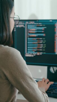 Vertical Screen : Young adult Asia female freelance eyeglasses typing write prompt AI bot app smart program nomad, video game, terminal coding, user interface, designer, big data center on computer.