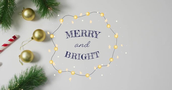 Animation of merry and bright text over decorations