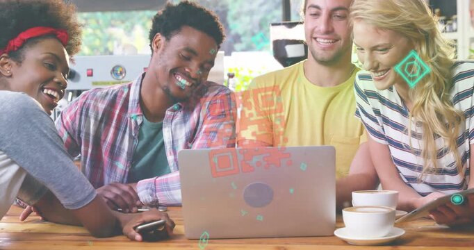 A group of friends are using a laptop in a cafe while enjoying cup of coffee