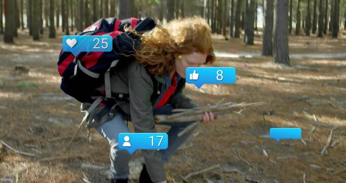 woman crouching and gathering sticks in forest, with floating marketing icons showing engagement