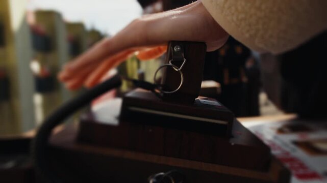 Person hand using a wooden rubber stamp