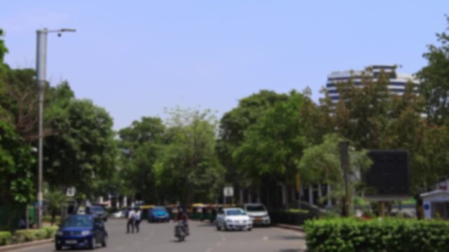 Calm vehicle daytime traffic near Connaught Place with Gopaldas Bhawan building at the background in New Delhi, India. Bokeh real time mition video for background.	