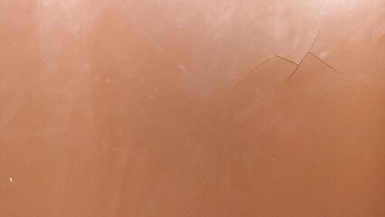 Fototapeta premium Subtle Cracked Brown Surface Texture Background. Minimal brown surface with fine cracks and soft wear, clean abstract texture for background use