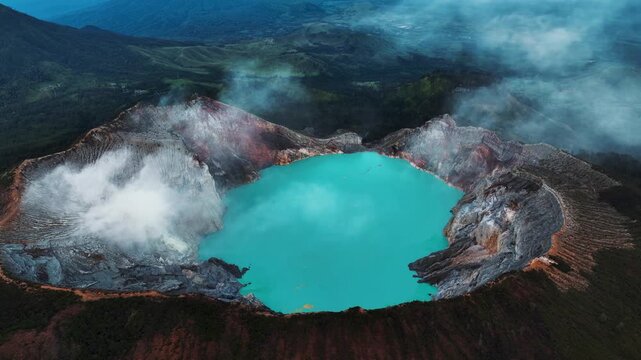 Cinematic aerial drone footage of Mount Ijen featuring its dramatic crater, turquoise sulfur lake, and volcanic landscape.