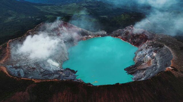 Cinematic aerial drone footage of Mount Ijen featuring its dramatic crater, turquoise sulfur lake, and volcanic landscape.