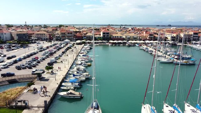 Aerial view of Lefkas Marina in Lefkada, Greece, lively coastal capital in summer day, boats in turquoise Ionian waters, Mediterranean lifestyle.