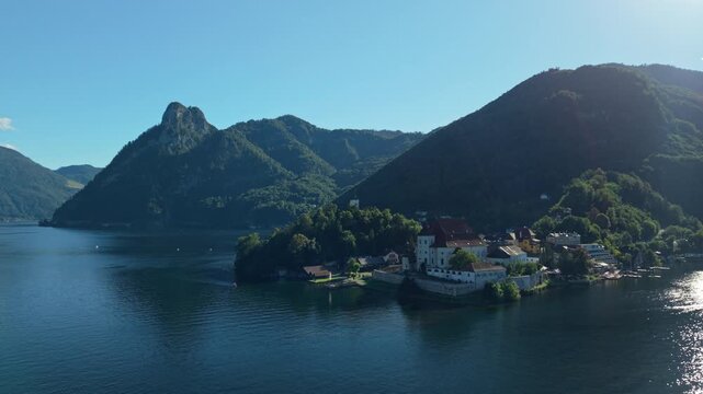Aerial view of Traunkirchen church on Traunsee lake and mountains, Austria