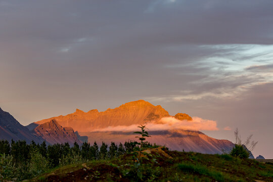 Rugged mountains rises against the horizon across Northern Iceland under heavy, brooding skies