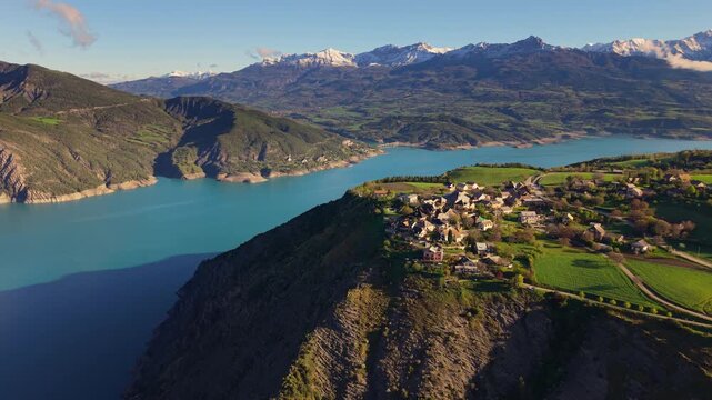 Aerial view of Le Sauze-du-Lac village with Serre-Poncon lake in spring. Durance Valley. Hautes-Alpes (Alps), France