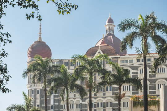 The Taj Mahal Palace luxury hotel on the seaside promenade Gateway of India with palm trees