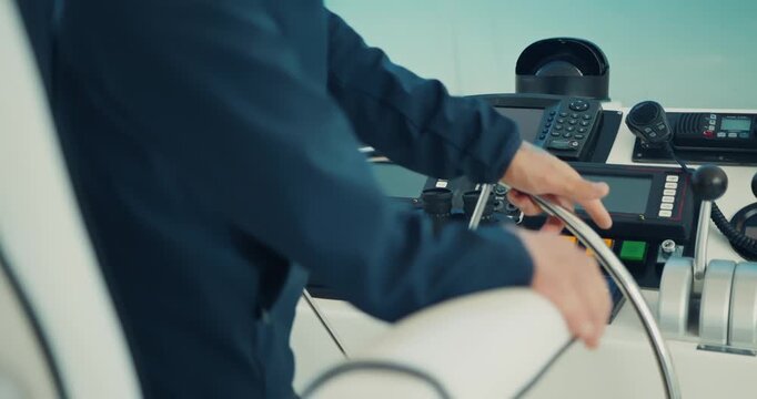 Person Steering a Boat at Control Panel