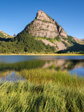 Lac des Sagnes and the pyramidal La Tour des Sagnes peak in Mercantour National Park. Mountain lake in the French Alps. Summer in Alpes-de-Haute-Provence, France