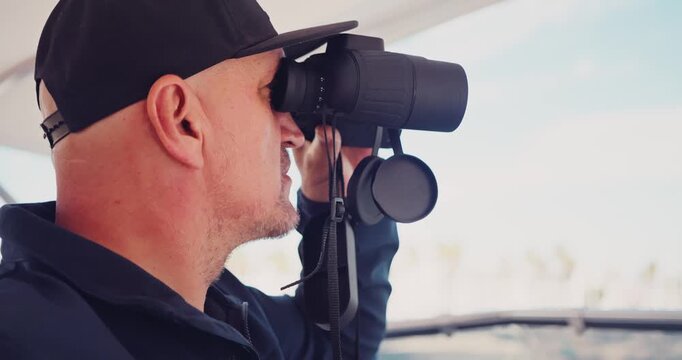 Man Observing Through Binoculars on a Boat