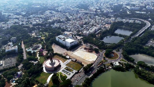 Aerial view of Dr. B. R. Ambedkar Statue near Hussain Sagar, showcasing landscaped gardens, road networks, and surrounding urban areas.