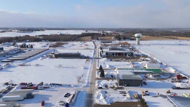 Commercial Buildings In A Industrial Neighbourhood Of Erin In Ontario, Canada During Winter. Aerial Flyover.