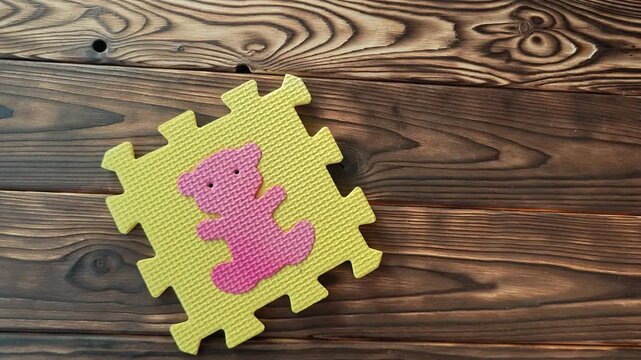 Hands join foam puzzle pieces to match shapes and colors at home.