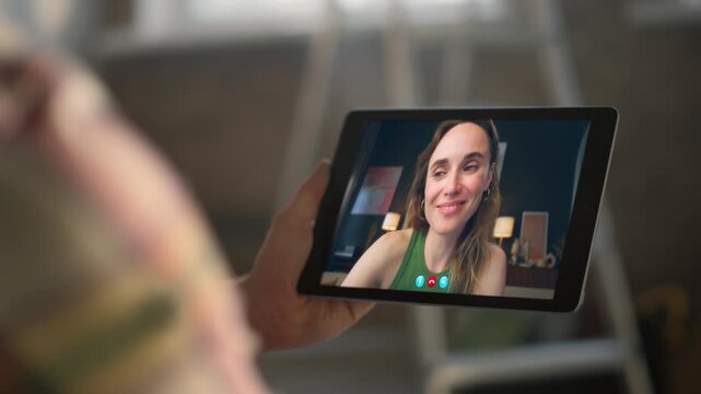 Smiling girl enjoying videochat in tablet computer screen online at flat closeup
