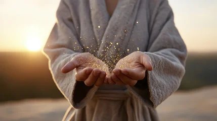 Fototapete Mädchenzimmer Gentle hands holding magical golden light in morning robe outdoors  © Viktoriia