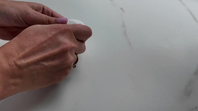 Peeling boiled egg removing shell by hand closeup