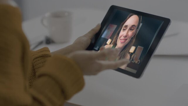 Girl talking tablet online indoors closeup. Unknown woman chatting web camera