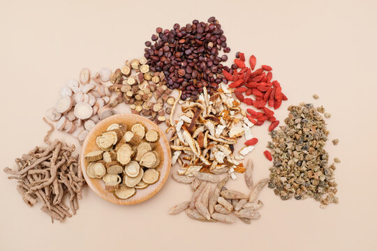 A variety of traditional Chinese medicinal herbs displayed in loose arrangement for close-up viewing