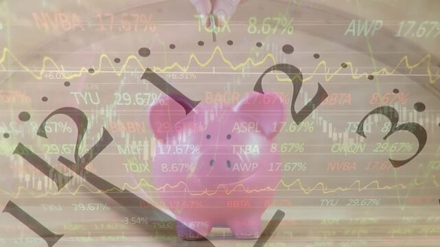 Animation of clock and stock market data over hand of caucasian woman inserting coin in piggybank