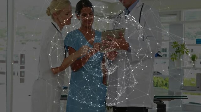 Medical team clustering around tablet and network sphere overlaying for reviewing patient data
