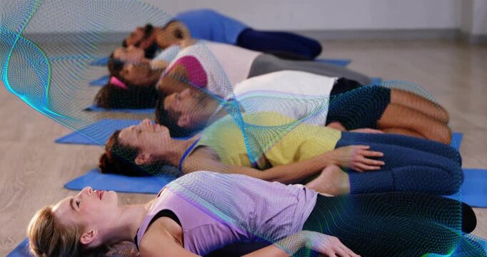 Six adults lying on blue mats on cue, animated wave marking breathing for fitness cooldown