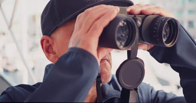 Man Observing with Binoculars on a Boat