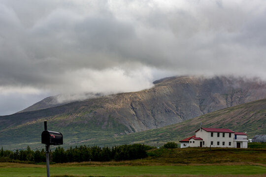 VILLAGE, EASTERN ICELAND, Mountains in the distance with a mailbox in the foreground