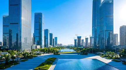 Naklejka premium Modern cityscape with towering glass skyscrapers surrounding a serene water plaza and landscaped greenery