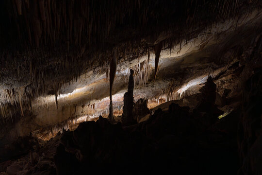 Close up view of stalactites and stalagmites in cave showing detailed natural geological formations