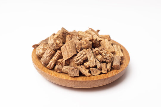 Dry Codonopsis pilosula root slices are placed in a wooden bowl