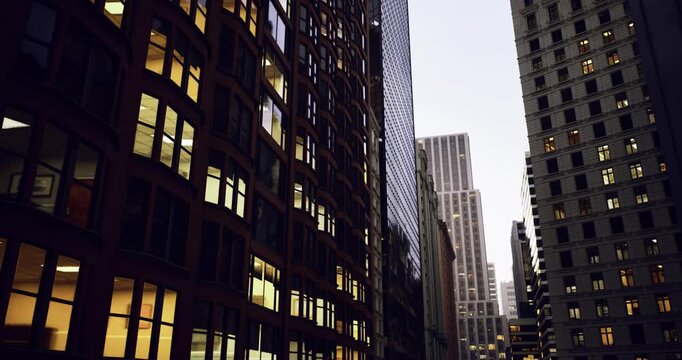 twilight glass facade with deep reflections and lit offices, mirrored surfaces creating symmetry, narrow urban passage lined with modern towers, quiet city mood