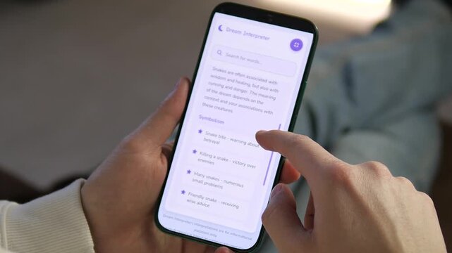 User exploring snake symbolism on a Dream Interpreter mobile app. High-quality footage for psychology blogs, self-help guides, and modern spirituality content. Clean purple UI design and smooth