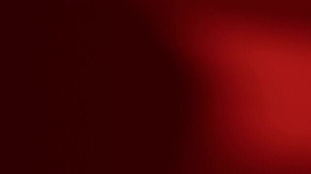 Una toma de cerca de un fondo abstracto de color rojo o anaranjado con negro un degradado ligero desenfocado en movimiento