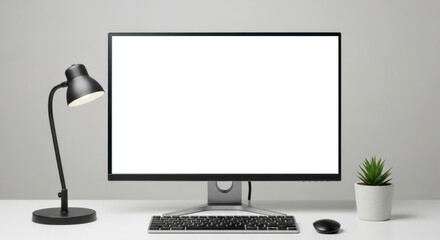 Fototapeta premium A modern workspace setup with a black monitor, keyboard, and mouse on a white desk.