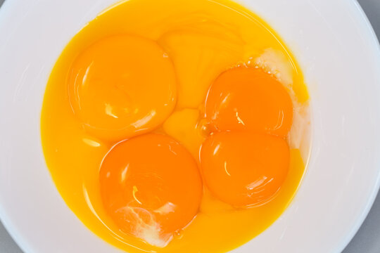 Broken chicken eggs, one of them double-yolk, top view