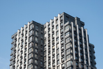 Fototapeta premium Modern apartment building corner perspective against blue sky