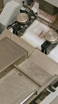 Polygraph process inside - folding machine on printing industry - the sheets of paper moving through the pipeline