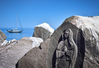 Relief of Our Lady carved into the rock in the marina Loreto, Mexico, Baja California Sur stock...