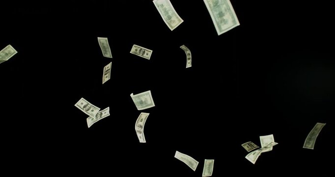 US dollar banknotes flying in super slow motion against black background. Floating money bills drifting and falling in the air, symbolizing wealth, finance and luxury in cinematic detail.