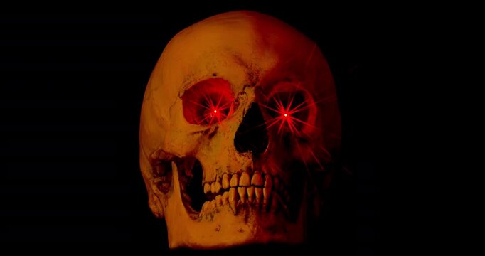 Skull with Glowing Red Eyes. Video of motionless human skull with bright red glowing eyes and fast shifting neon colored lights on black background.