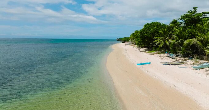 Beach in Lanas, San Jose. Beautiful sandy beach with clear turquoise water. Carabao Island. Romblon, Philippines.
