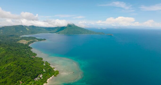 Tropical landscape of Island with turquoise water at coast. San Agustin, Tablas Island. Romblon, Philippines.